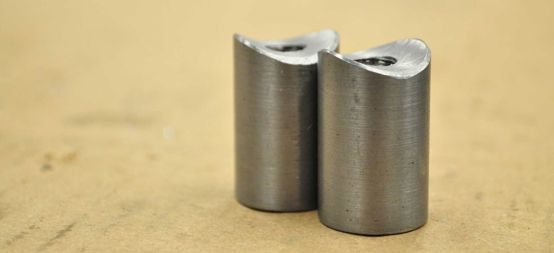 Two threaded bungs sitting together